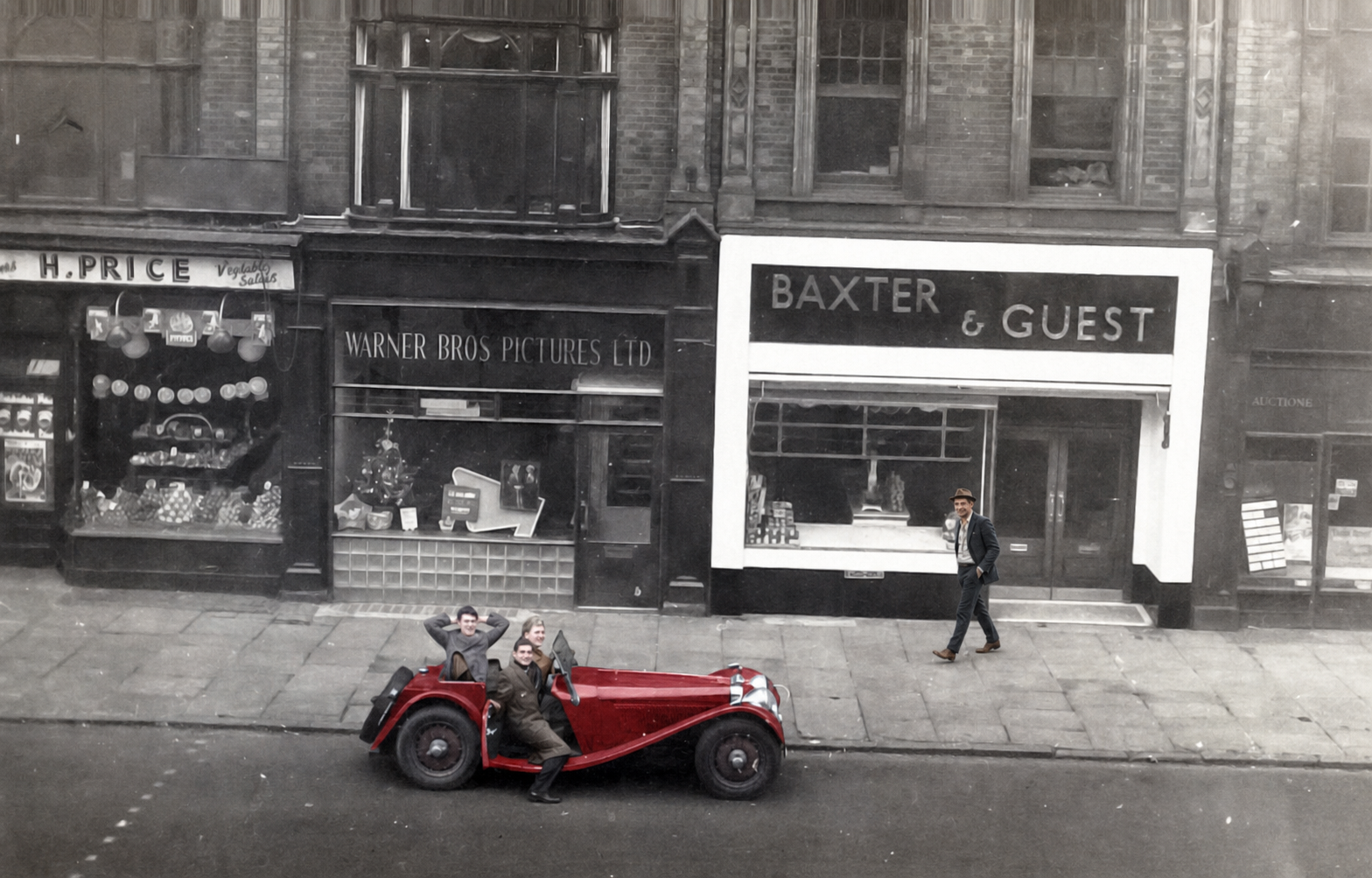 Charlie Wainwright walks along the pavement as the Jaguar photograph slowly develops from black and white into colour